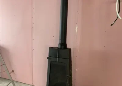 Conduit d'un poêle à bois dans habitat en construction - B Services